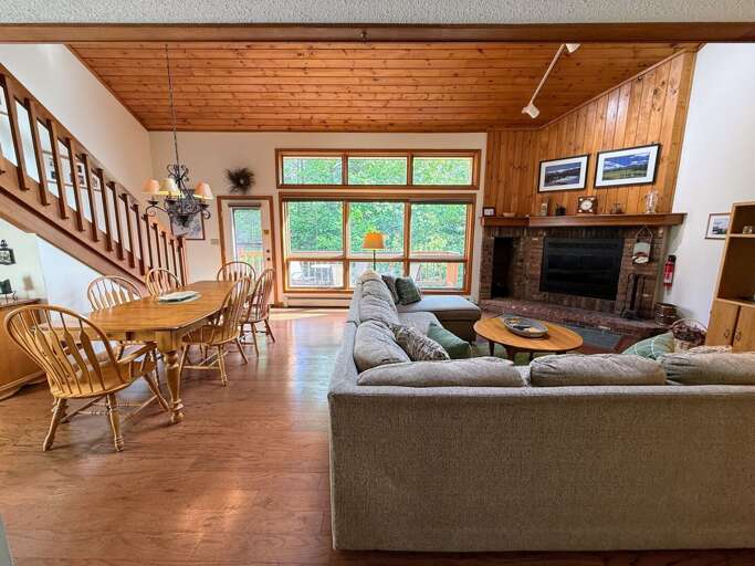 Main living area is an open concept space with living area, dining, breakfast bar, and kitchen right as you walk in.