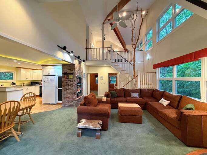 This comfortable home is accented with brick and a natural tree post in the staircase.