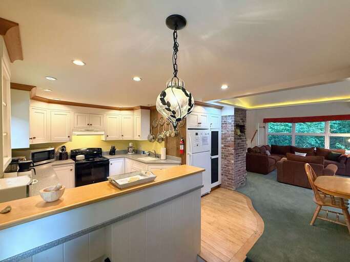 The kitchen is outfitted with standard appliances, a toaster oven, Kitchenaid mixer, and a drip coffee maker.