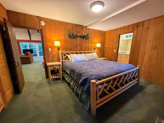 The primary bedroom is on the main level and has a King bed and ensuite bathroom with shower.