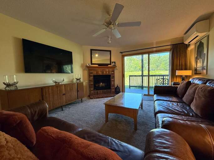 Living area with comfortable seating, gas fireplace and TV