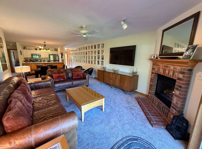 Living room offers comfortable seating, a gas fireplace, and TV.