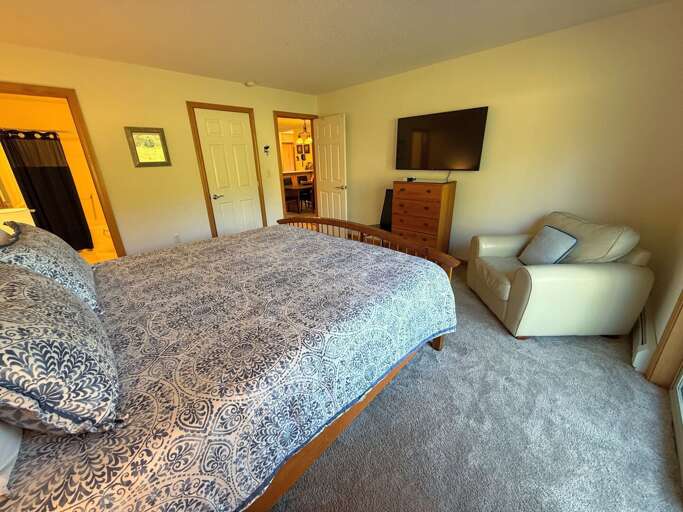 Primary bedroom with King bed, TV and ensuite bath.