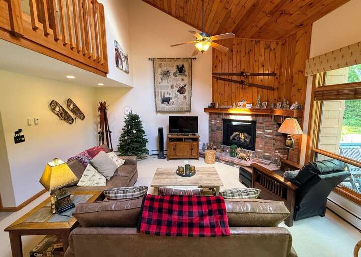 Living area offers a smart TV, gas fireplace and deck access