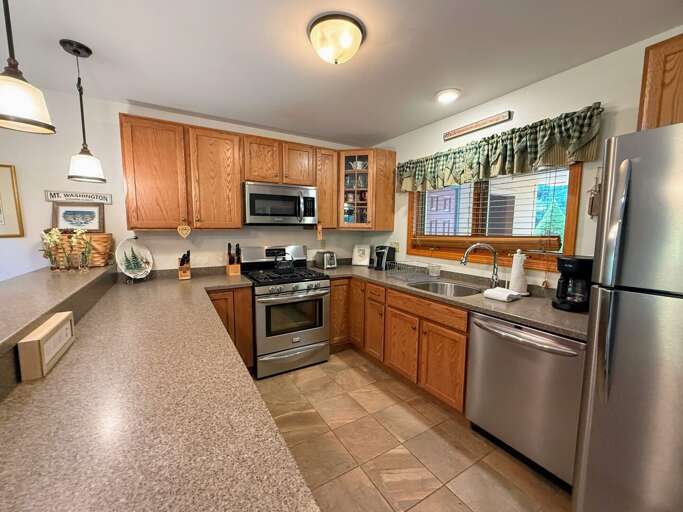 Lots of counter space and stainless steel appliances make this a very comfortable kitchen.