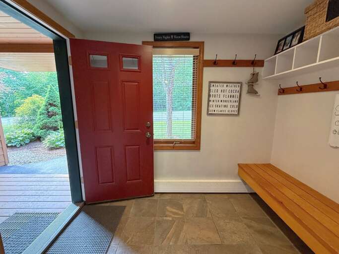 Spacious entryway with hooks and storage.