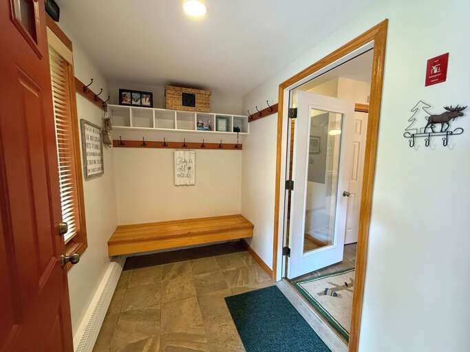 Spacious entryway with hooks and storage.