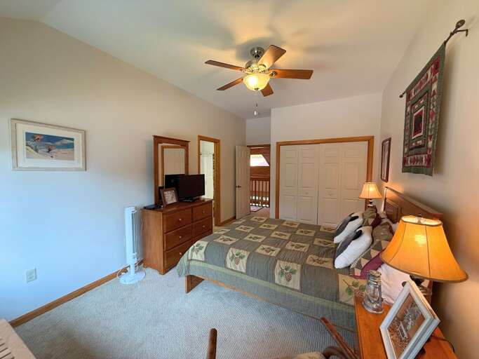 Upper level Queen Bedroom with TV, closet, and ensuite bath.