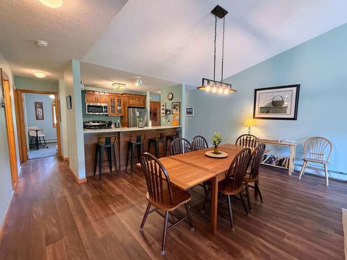 Dining table with seating for 6 + an extra chair and 4 stools at the breakfast bar.