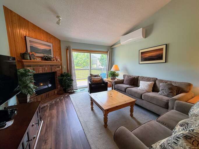 Living area with gas fireplace, comfortable seating, Smart TV, DVD player and walkout to the deck.