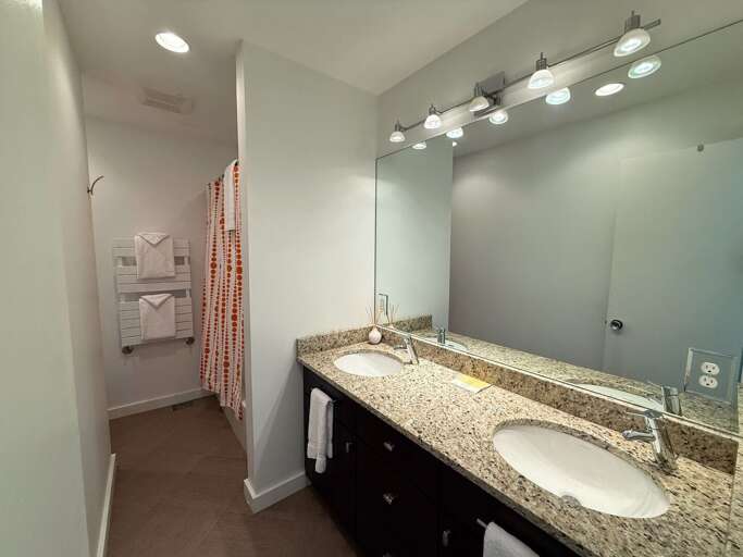 Lower level bathroom with double vanity and shower/tub combo