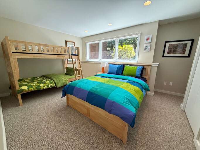 Lower level bedroom with queen bed and twin-over-twin bunk.