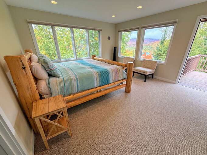 Upper level king bedroom with ensuite bathroom and private deck.
