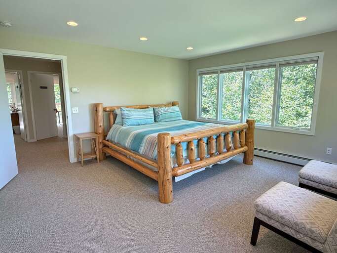 Upper level king bedroom with ensuite bathroom and private deck.