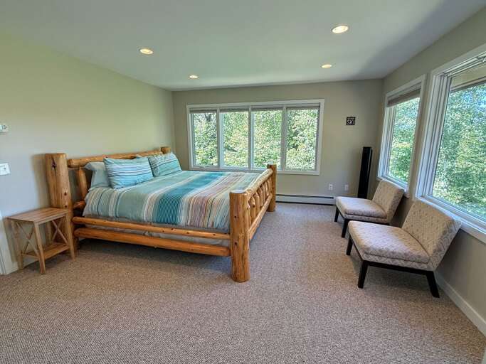 Upper level king bedroom with ensuite bathroom and private deck.