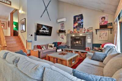 Ski-themed living room combining cozy mountain vibes with personal pop-culture touches. Large, light