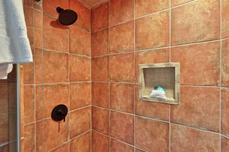 Rainfall shower head and custom tile work. Wash off the trail dust in a spa-inspired setting.