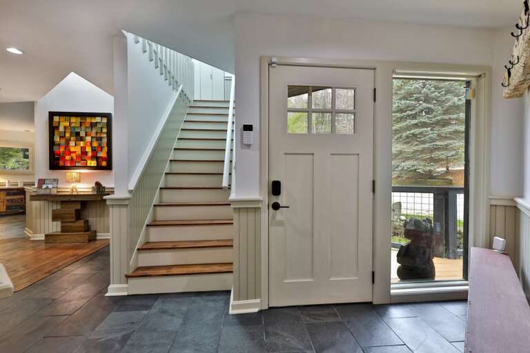 Slate flooring in the entryway handles wet boots and gear. Durable design built for Vermont winters.