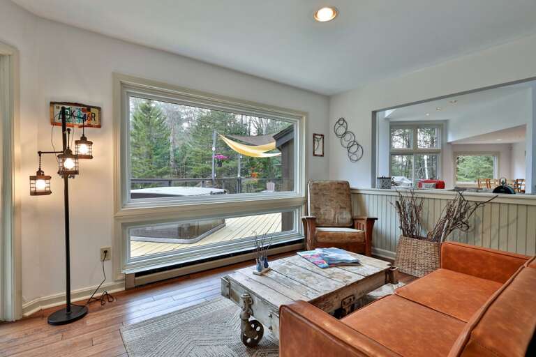 The sunroom looks out to your private deck. Check the hot tub temperature without stepping outside.