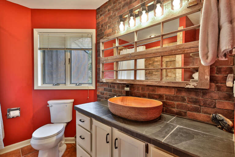Unique brick and stone bathroom finishes. Industrial-chic design that feels distinct and memorable.