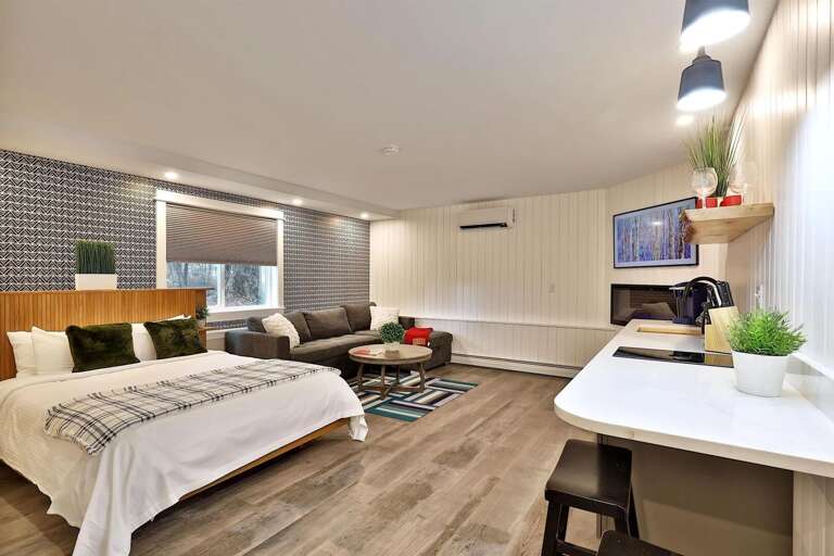 A plush queen bed and stylish accent wall. Sleep soundly after a day on the slopes.