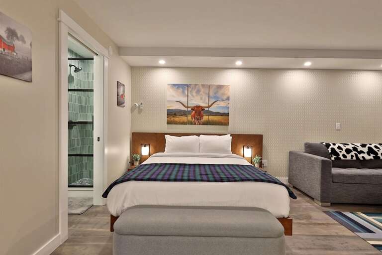 A peek into the modern, fully renovated bathroom, just steps from the queen bed.