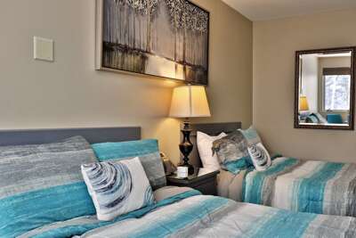 The two comfortable full beds and some of the tasteful decorations of our cozy hotel-style studio at Killington Center Inn and Suites, nestled in the heart of Killington, Vermont.