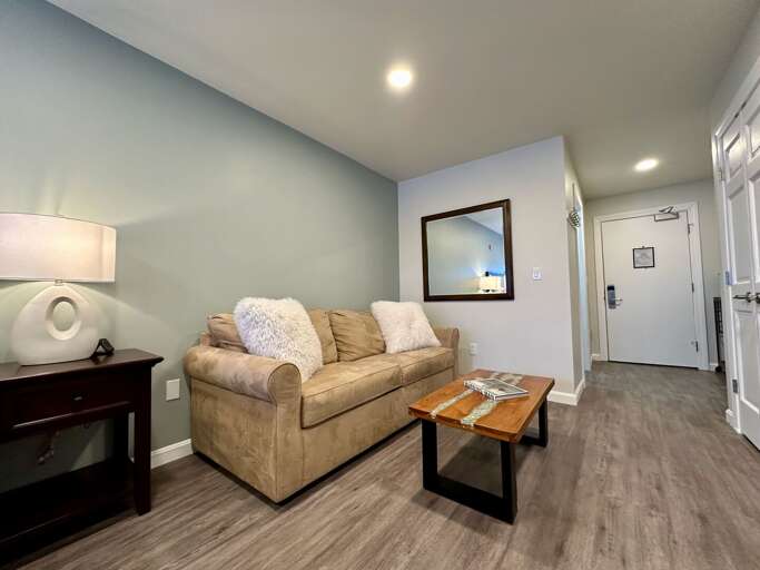 Kick back in our cozy studio, with a comfy couch perfect for lounging. Enjoy your morning coffee at the charming coffee table. It's the perfect spot to start and end your vacation days!