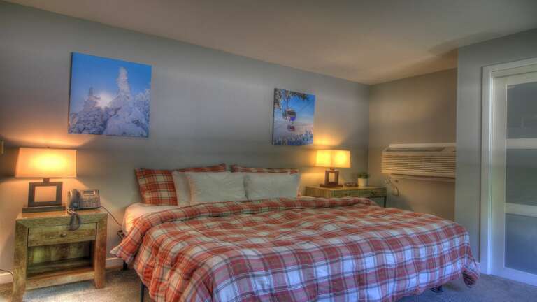 Experience comfort in a beautifully decorated bedroom featuring a cozy king bed.