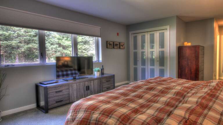 Experience the comfort of our cozy bedroom, complete with a luxurious bed and smart TV for your entertainment.