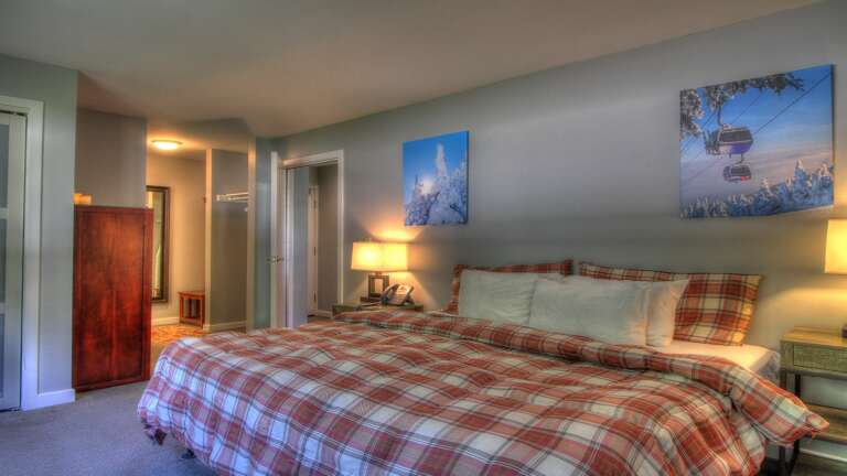 Experience tranquility in our cozy bedroom featuring a comfortable bed.