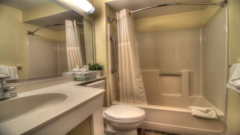 Primary bedroom features a well-equipped ensuite bathroom complete with toilet, sink, and a refreshing shower.