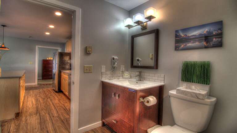 This property features a neatly designed bathroom equipped with a modern sink and toilet.