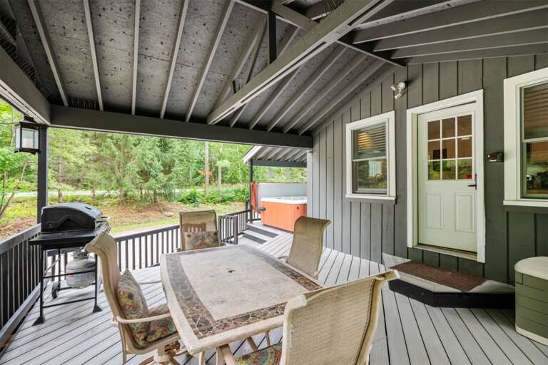 Cook outside, pass plates around the table, and keep the wooded yard in view.