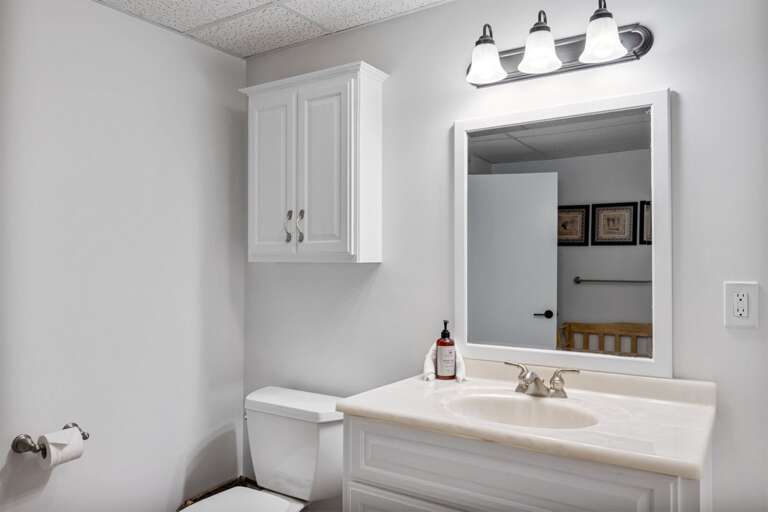 Counter space at the sink sits opposite the washer and dryer.