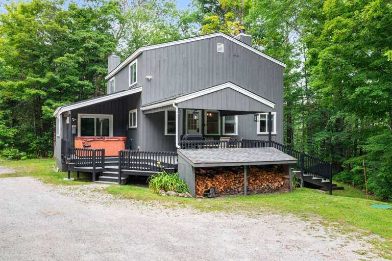 Two decks wrap the house, with the covered hot tub and outdoor dining close at hand.