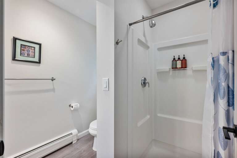 The enclosed shower room leaves the vanity available just outside.