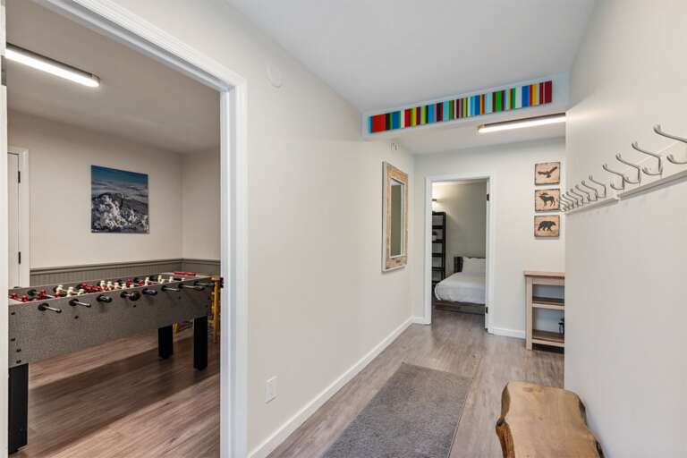 Foosball is only a few steps from the bedrooms, with hooks and a bench nearby for bags and layers.