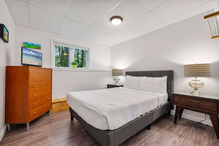 Lamps on both sides of the bed make late-night reading easy, with the TV across the room.