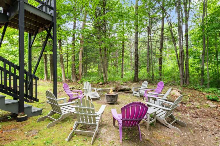 Pull an Adirondack chair to the fire and trade stories beneath the trees.