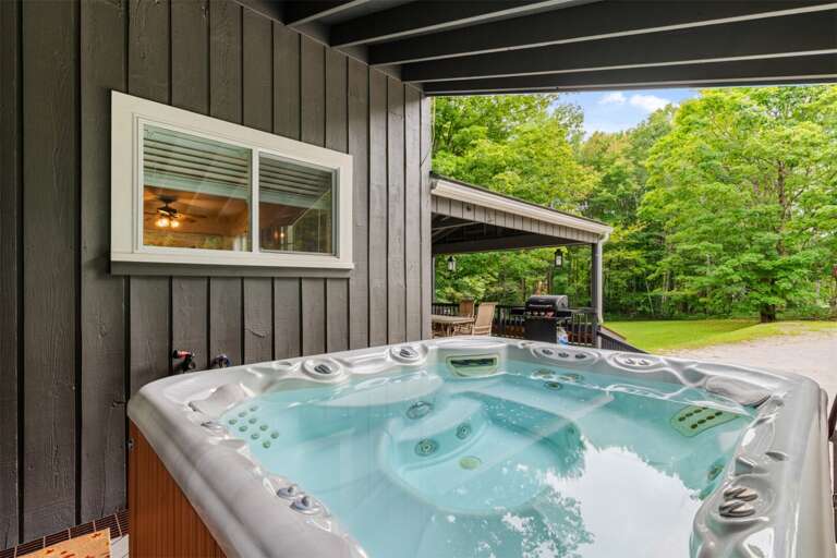 Rain or shine, the covered hot tub is ready for a quiet soak among the trees.
