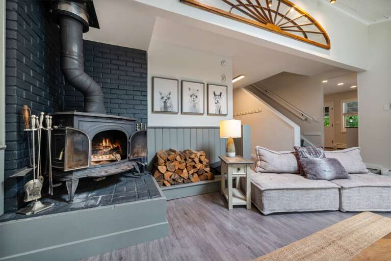 Stacked firewood is ready beside the stove when the evening calls for a real fire.