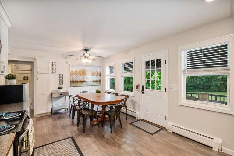 The round table catches natural light and sits an easy step from both the kitchen and deck.