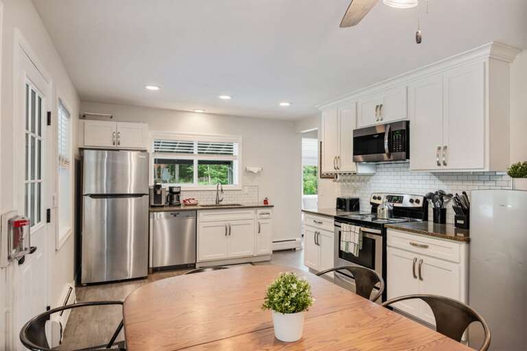 The round table sits beside the renovated kitchen for breakfasts and dinners at home.