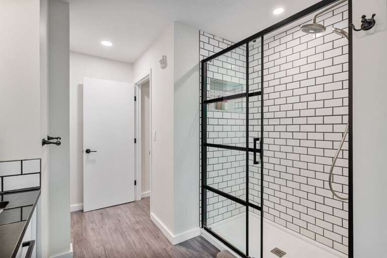 The tiled walk-in shower is fitted with a fixed showerhead and a handheld option.