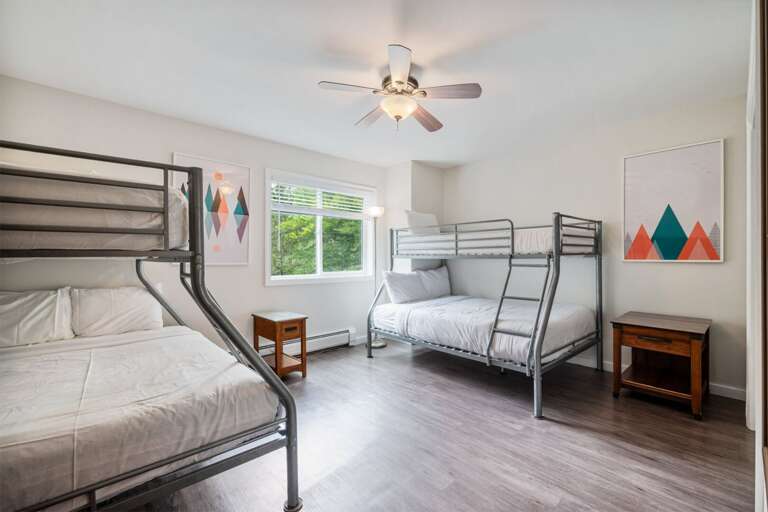 Two twin-over-full bunk beds make this a practical room for a larger sleeping group.