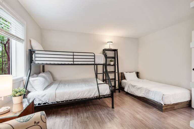 A twin-over-full bunk and separate twin bed give family or friends several sleeping options in one room.