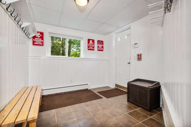 A wall cabinet keeps essentials above the toilet beside the vanity.