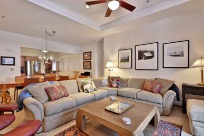 Enjoy a spacious living area with a large dining table, cozy sofas and a gas fireplace.