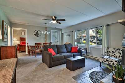 Dining area and stylish living room with calm Vermont landscape views at The Snowshed Steps, at walking distance to the base area of Killington Mountain.